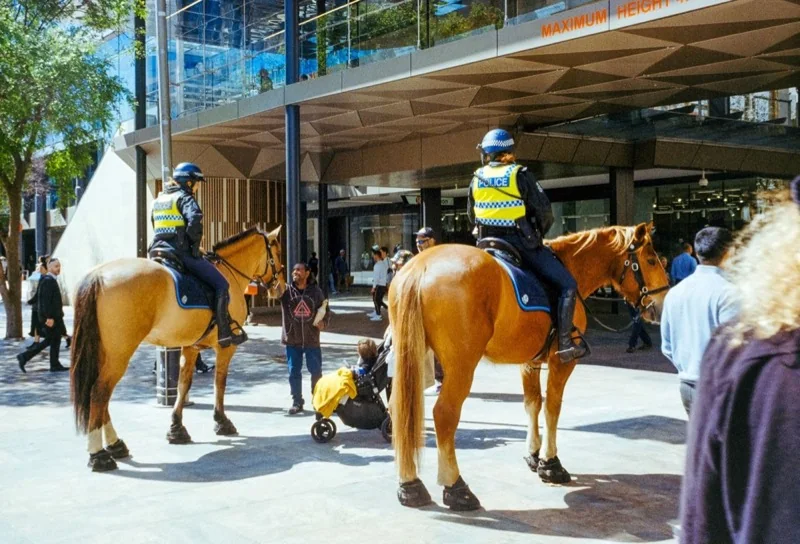 two police officers on horses in a city — illustrative editorial photography, not a verified location