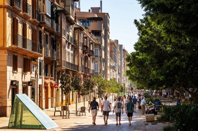 sunny street view in european city with pedestrians — illustrative editorial photography, not a verified location