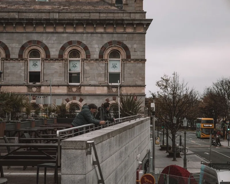 people walking on sidewalk near brown concrete building — illustrative editorial photography, not a verified location