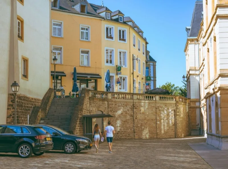 couple walking in alley in luxembourg — illustrative editorial photography, not a verified location