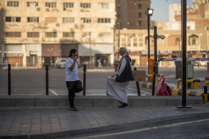 casual conversation in urban street setting — illustrative editorial photography, not a verified location