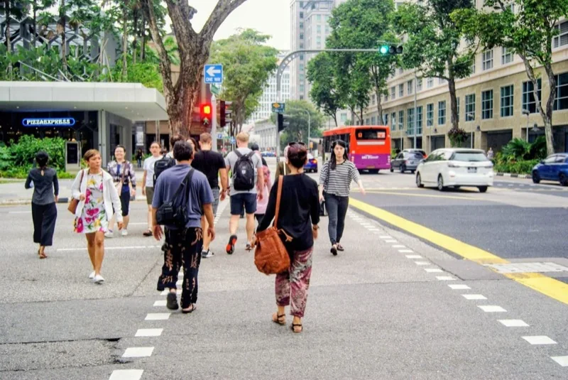 pedestrian crossing in bustling singapore street scene — illustrative editorial photography, not a verified location