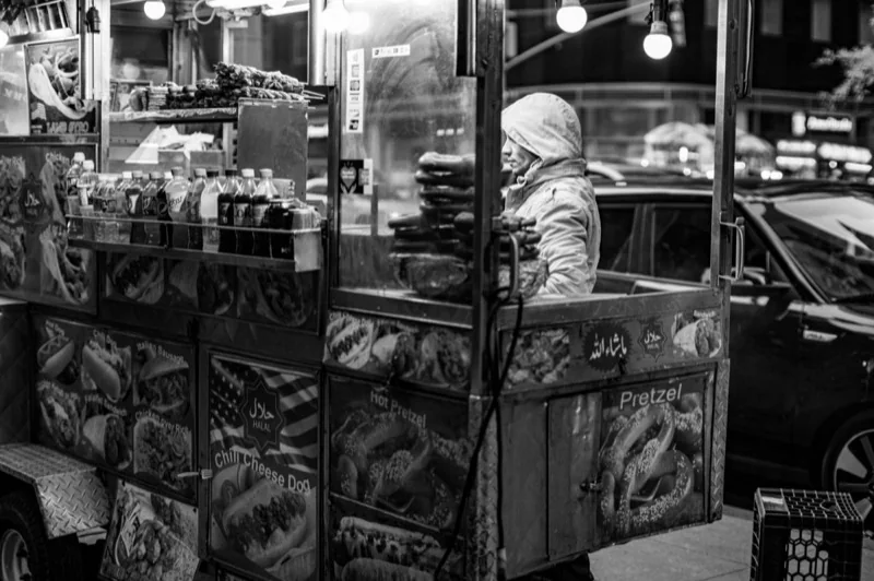 grayscale photo of street vendor — illustrative editorial photography, not a verified location
