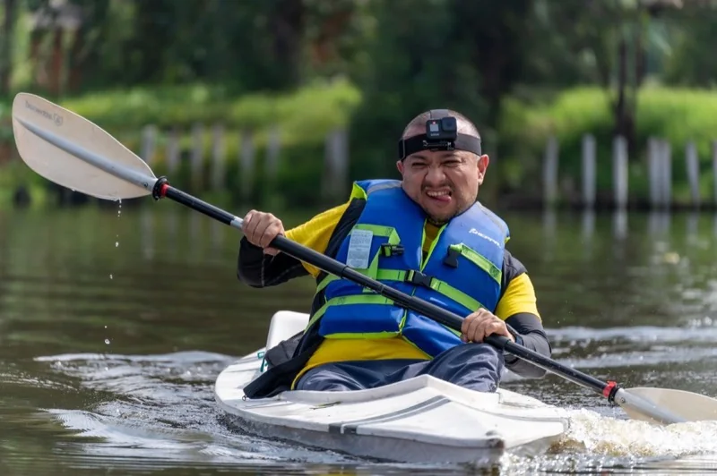 A kayaker paddling on calm water