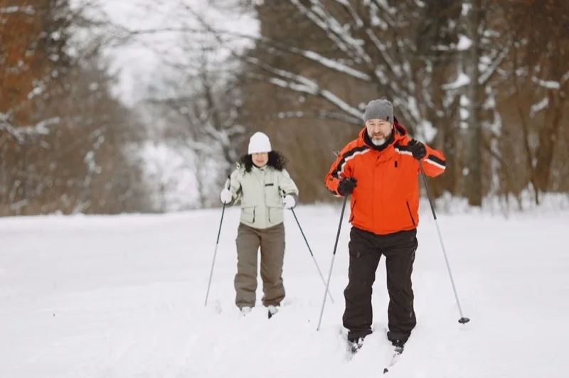 Two skiers on a snow-covered trail